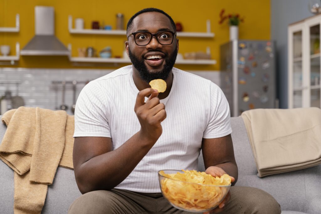 man-watching-tv-eating-chips-1024x683-1