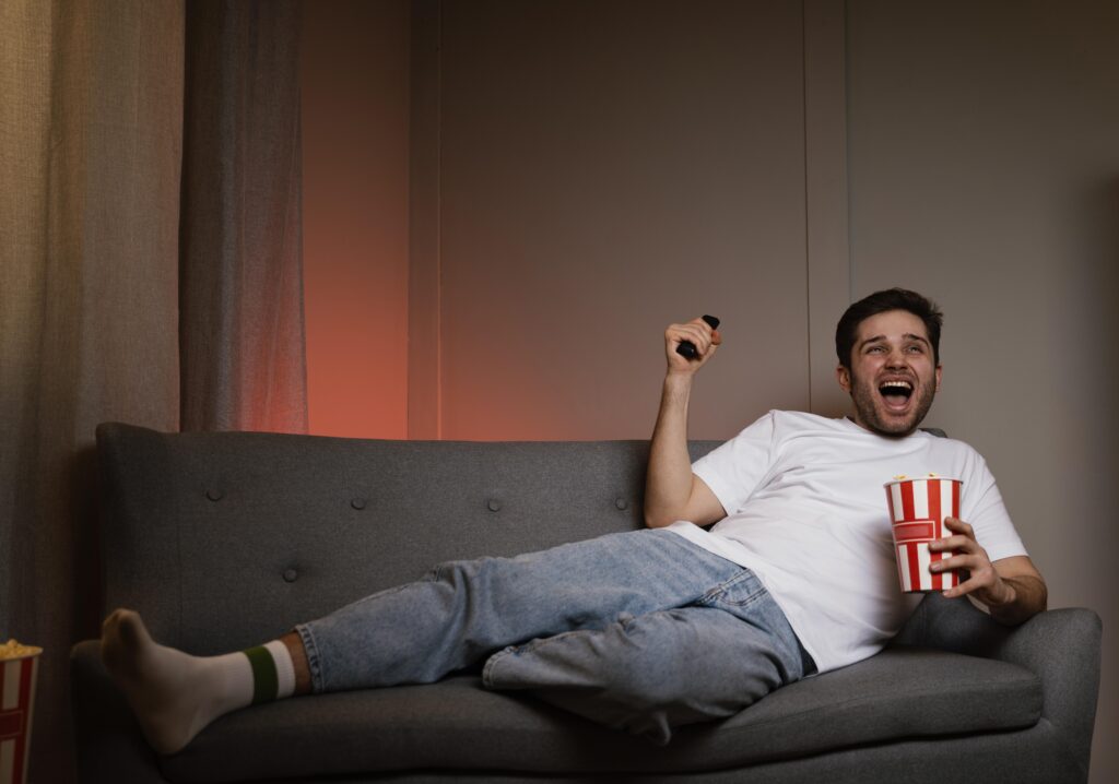 man-watching-tv-eating-popcorn-1024x718-1
