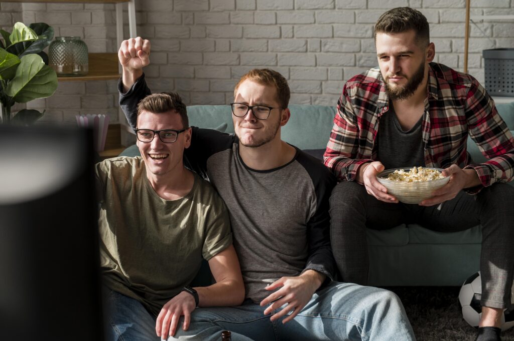 front-view-male-friends-watching-sports-tv-having-snacks-together-1024x681-1