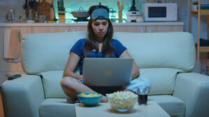 Typing on laptop and watching tv