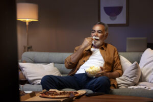 man-enjoying-food-while-being-home-alone-watching-tv-1024x683-1