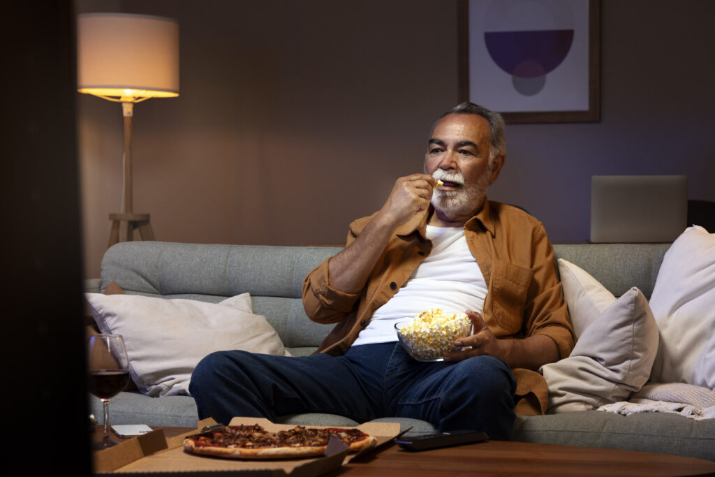man-enjoying-food-while-being-home-alone-watching-tv-1024x683-1