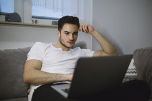 man-using-laptop-living-room-1024x683-1