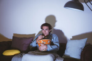man-watching-movie-eating-popcorn-1024x683-1