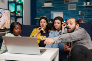 Multi-ethnic friends spending time together looking at entertainment movie